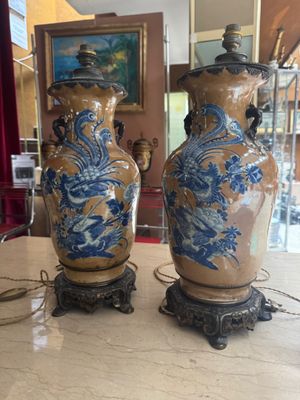 two vases sitting on a table in a room