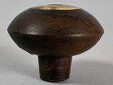 a small wooden object that looks like a mushroom