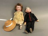 two dolls sitting next to each other on a table