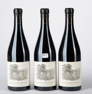 trois bouteilles de vin posées sur une table blanche