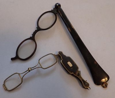 a pair of glasses, a pen, and a pair of glasses on a table