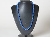 un collier de perles bleues sur un mannequin noir