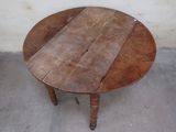a small table with a wooden top on a concrete floor