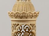 a figurine of a bell tower with a cross on top of it