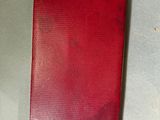 an old red cigarette case sitting on top of a table