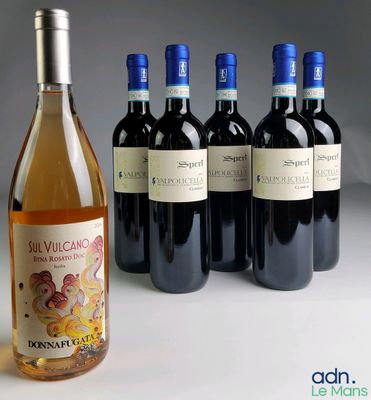 several bottles of wine sitting next to each other on a table