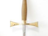 a sword hanging on the wall with a wooden handle