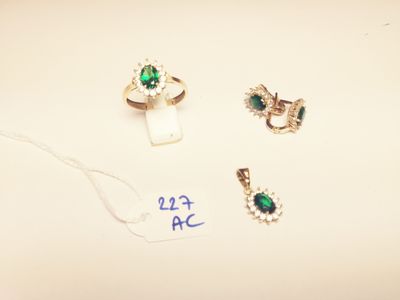 three rings and a necklace are on a table with a price tag