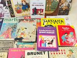 many children ' s books sitting on a table together