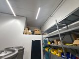 a room with a lot of shelves and bins in it