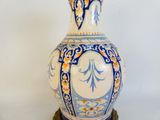 a blue and white vase sitting on top of a table