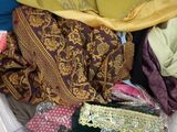 a basket full of clothes that is sitting on a bed