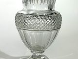 a glass vase that is sitting on top of a table