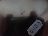 a close up of a metal object with a tag on it