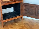 a wooden cabinet with a door open on the floor