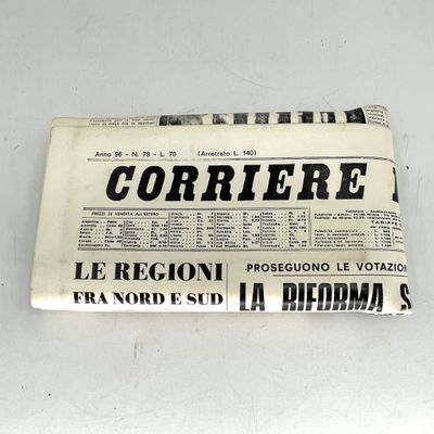 newspaper on a white table with a black and white image of a newspaper