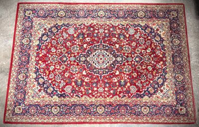 a red rug with a medallion design on it