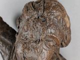 a wooden statue of a man holding a baseball bat