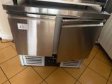 a stainless steel dishwasher sitting on top of a tiled floor