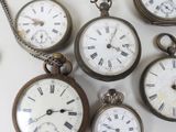 many different types of pocket watches on the table