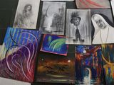 many different paintings on the floor of this room