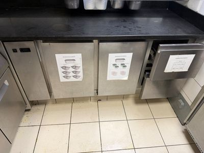 a picture of a commercial kitchen with stainless steel appliances