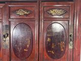 a wooden cabinet that has a drawer underneath it