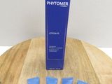 three tubes of phytomer sitting on a wooden table next to a tube of phytomer