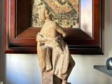 a statue of a woman sitting on top of a pile of books