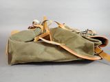 a bag that is sitting on the ground with a pair of shoes in it