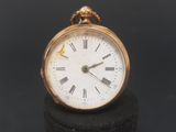 a gold pocket watch with roman numerals on the face