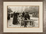 a black and white photo of a group of people and a dog