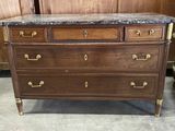 an image of a wooden dresser with marble top in a room