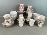 a lot of cups and saucers on the table