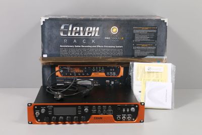 an orange and black radio sitting on top of a table next to a box