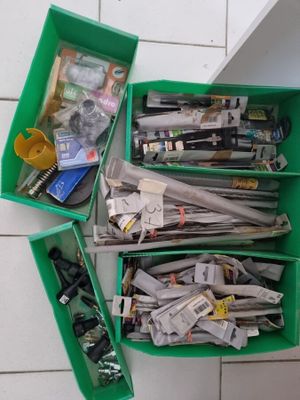 a lot of newspapers in the green bins on the floor
