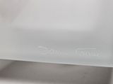 a clear glass plate with a white writing on it