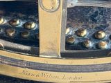 a close up of a brass plate with a clock on it