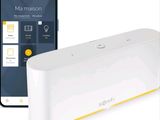 une image représentant un appareil connecté, avec un smartphone à côté