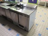 a kitchen with two sinks and a refrigerator in it