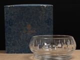 a glass bowl sitting on top of a table next to a box