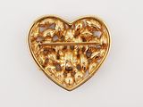 a close up of a gold heart shaped brooch