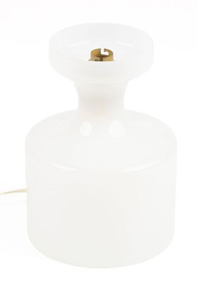 a white glass table lamp with a gold metal base