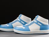 a pair of blue and white sneakers on a gray surface