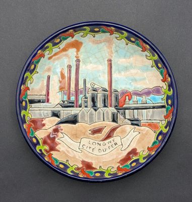 a plate with a picture of a factory on it