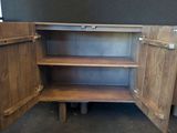a wooden cabinet with a door open on the floor