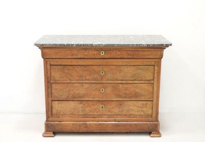 a small chest of drawers with a marble top