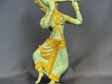statue of a woman playing a flute on a base