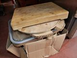 a wooden cutting board sitting on top of a cardboard box
