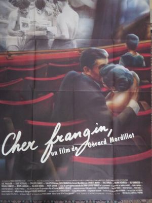affiche de cinéma représentant un homme et une femme dans une salle de cinéma